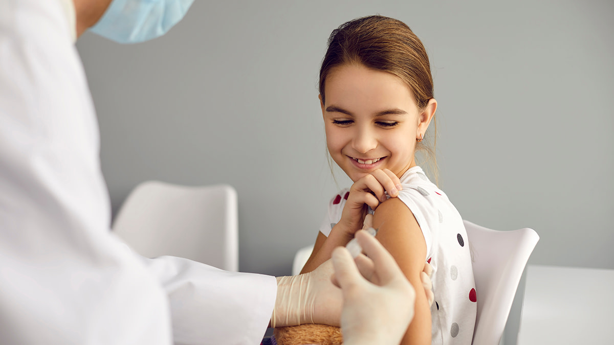 Girl receiving a vaccine at the doctors