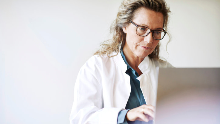 Female doctor using laptop